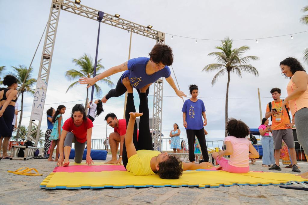 Pessoas praticando acroyoga na Orla